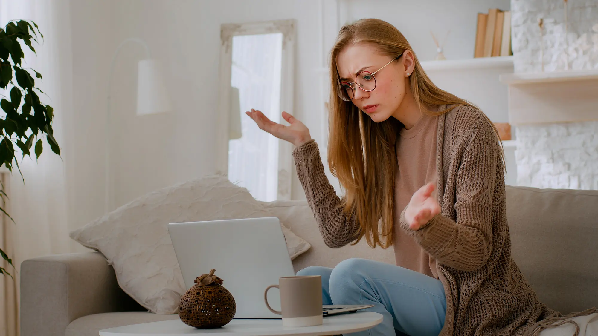 Person looking frustrated while using a laptop