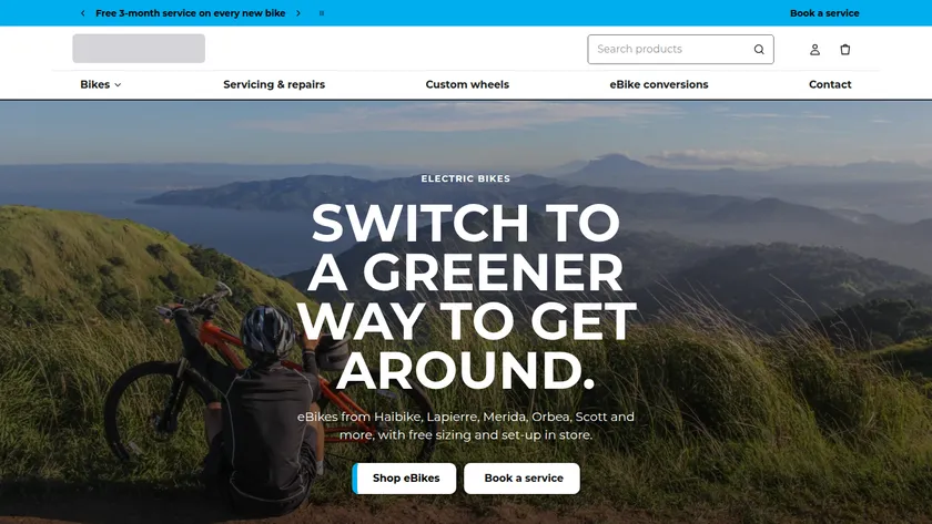 Shopify store homepage for a bike retailer with a full-width photo of a cyclist and buttons to shop eBikes or book a service